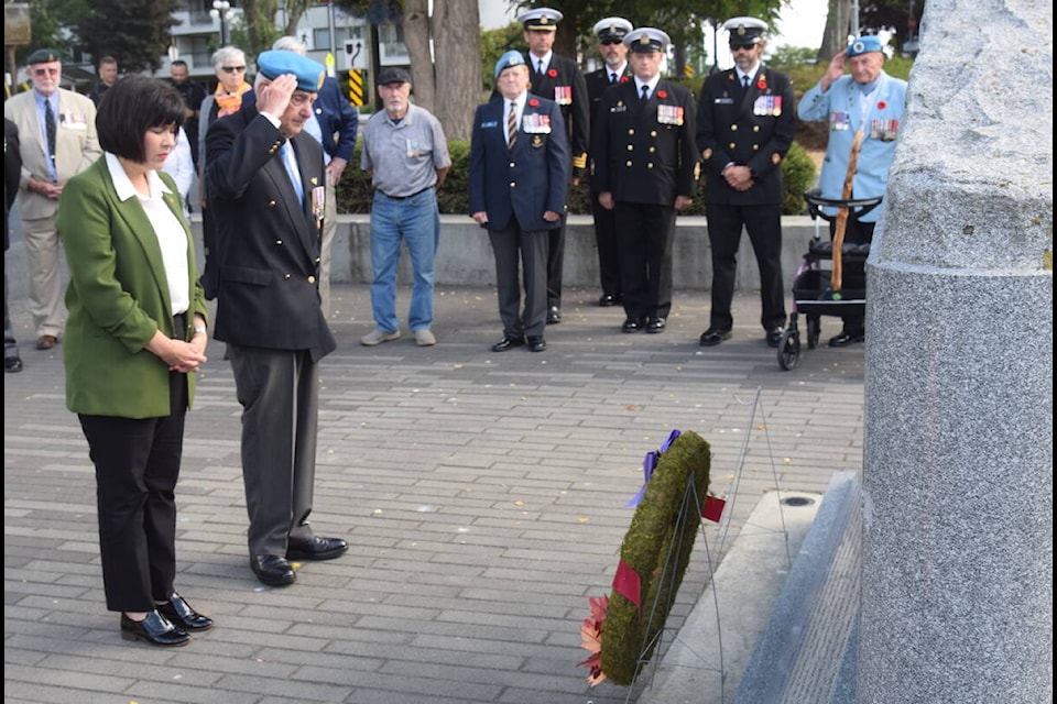 Veterans Affairs Minister Ginette Petitpas Taylor and Joseph ‘Larry’ Gollner, retired brigadier-general and president of the BC Afghanistan Memorial Society, lay a wreath at Victoria’s B.C. Afghanistan Memorial on National Peacekeepers’ Day. (Brendan Mayer/News Staff) 