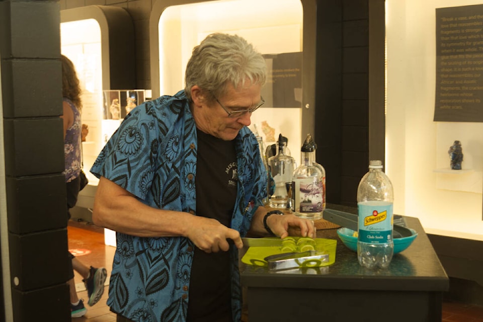 Misguided Spirits owner Darren Bellaart slices some limes for participants who came through the Campbell River Art Gallery to taste some of his liquor, during the Bevy About Town event on Aug. 18. Photo By Edward Hitchins/Campbell River Mirror 