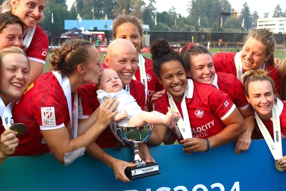 Krissy Scurfield (left) kisses a coaching staff member’s baby as the Canadian women’s sevens team celebrates their Olympic qualification after winning the Rugby Americas North (RAN) Sevens in Langford on Sunday (Aug. 20). (Bailey Moreton/News Staff) 
