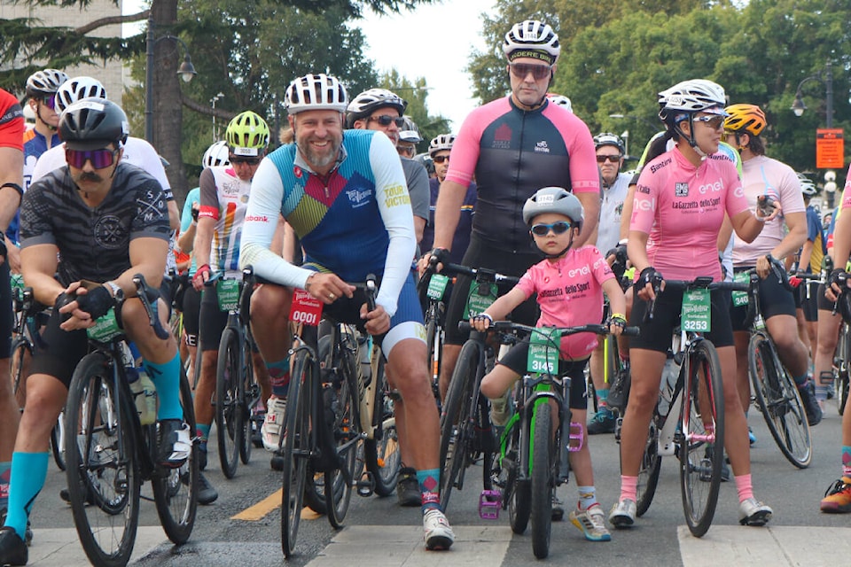 Ryder Hesjedal (left), who the Tour de Victoria is named after, at the start line alongside five-year-old Michael Greenway for the 60-kilometre race on Saturday (Aug. 19). (Bailey Moreton/News Staff) 