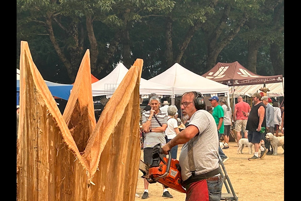 Rocky LaRock competes in the speed carve on Sunday, Aug. 20, during the Hope World Class Chainsaw Carving Event. (Adam Louis/Observer) 