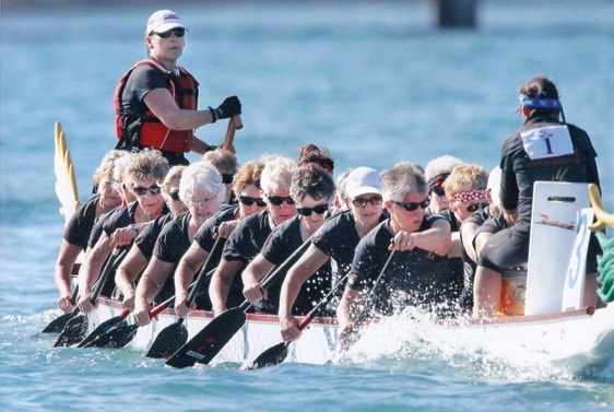 The Gorging Dragon's Women's 60-plus dragon boat team races through the water
