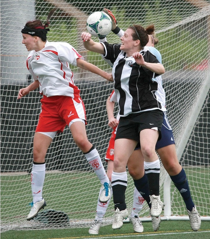 Dave Mann photo
Gorge's Janet Bisson, centre, leaps for a header