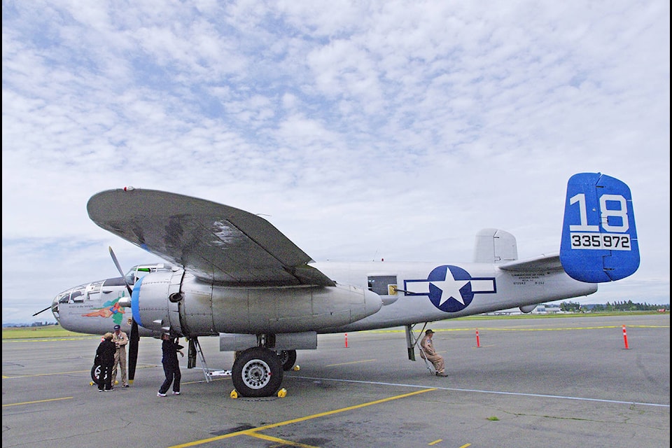 Check, contact Flight crew polish up the Maid in the Shade B-25 bomber following a short flight over the Saanich Peninsula Monday afternoon. The aircraft is at the Victoria airport this week, offering static displays and flights on the weekend. For more photos, turn to page 3. (Steven Heywood/News staff)