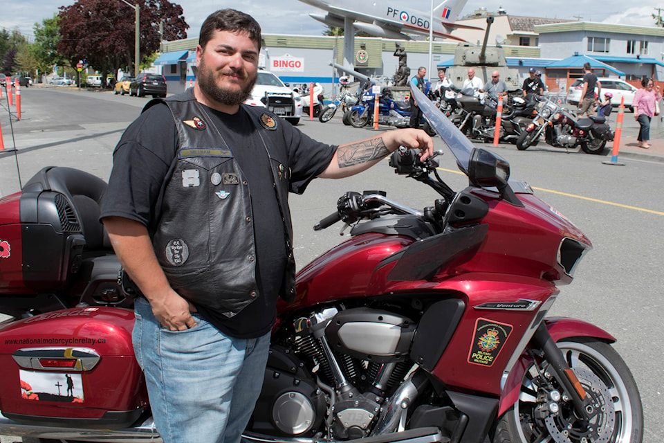 Cpl. Alex Millham poses in front of his motorcycle outside the Army, Navy and Air Force Veterans club in Sidney on Saturday. Millham aims to complete the entire cross-country tour this year. (Kevin Menz/News Staff)