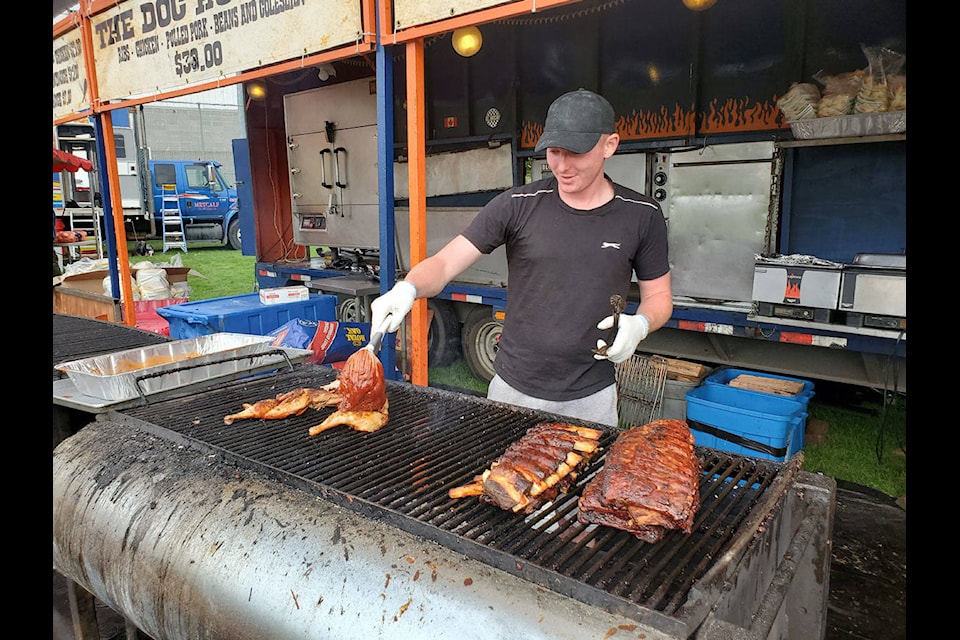 Jake Whittle of Hucklebellys putting their famous sauce on the chicken. (Jessica Williamson/Black Press Media)