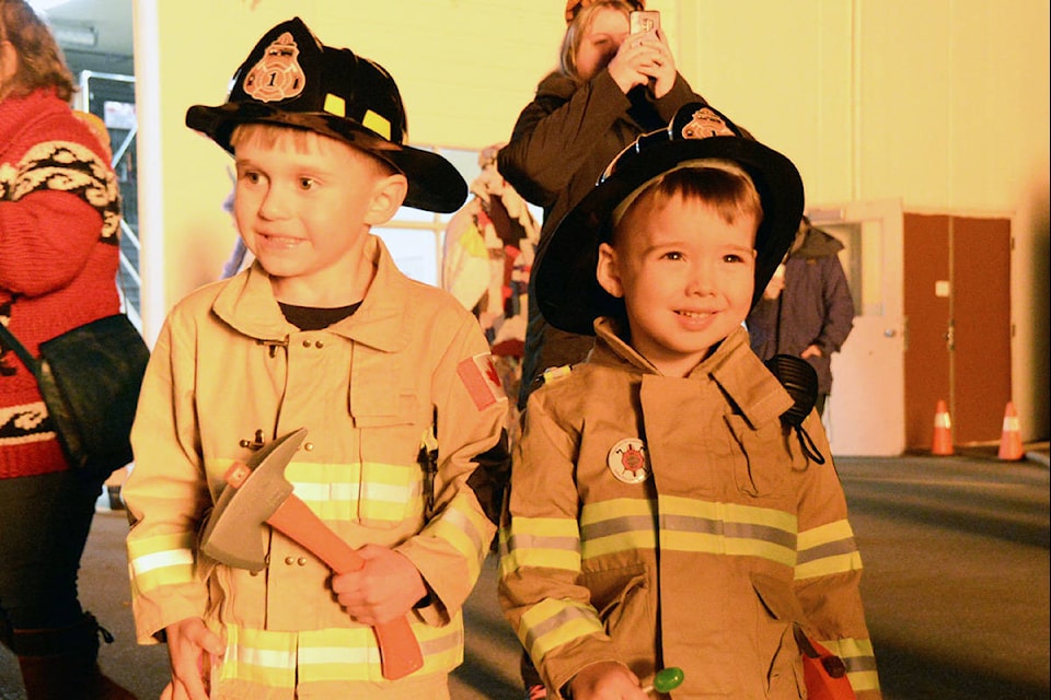 Mason Wise, 4, and Benjamin Turner, 3, came separately but both arrived in style and on theme to the Metchosin Fire Hall’s annual Halloween bonfire Thursday evening. (Nina Grossman/News Staff)