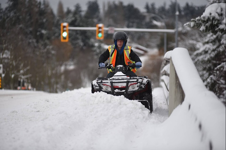 A mini snowplow clears sidewalks after up to 30 cm fell on Greater Victoria overnight. (Don Denton/News Staff)