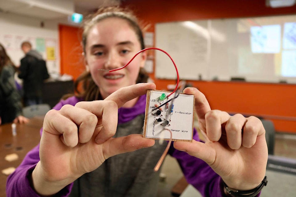 Grade 8 Dunsmuir Middle Schools student Makayla Graham shows off the printed circuit board she’s been working on. Graham and her classmates were at Royal Bay Secondary to learn about hands-on trades skills. (Aaron Guillen/News Staff)