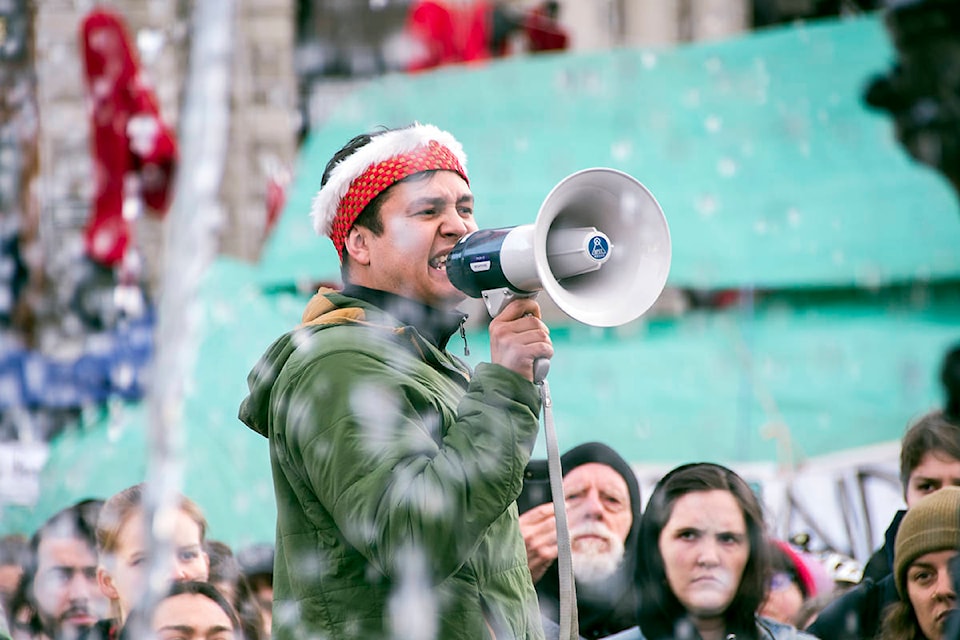 Indigenous land protectors, demonstrators and allies rallied outside the BC Legislature building Monday afternoon on the eve of the throne speech, scheduled for Tuesday morning. The group filled the government building’s fountain with red dye as a representation of “blood on the colonial government’s hands.” (Nina Grossman/News Staff)