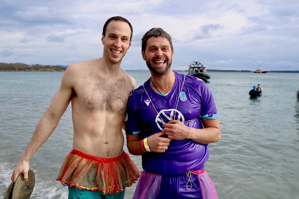 Paul Hanson, right, celebrated his birthday by participating in the Polar Plunge for Special Olympics BC at Willows Beach Sunday. Organizers have raised $40,000 in online donations alone. (Aaron Guillen/News Staff)