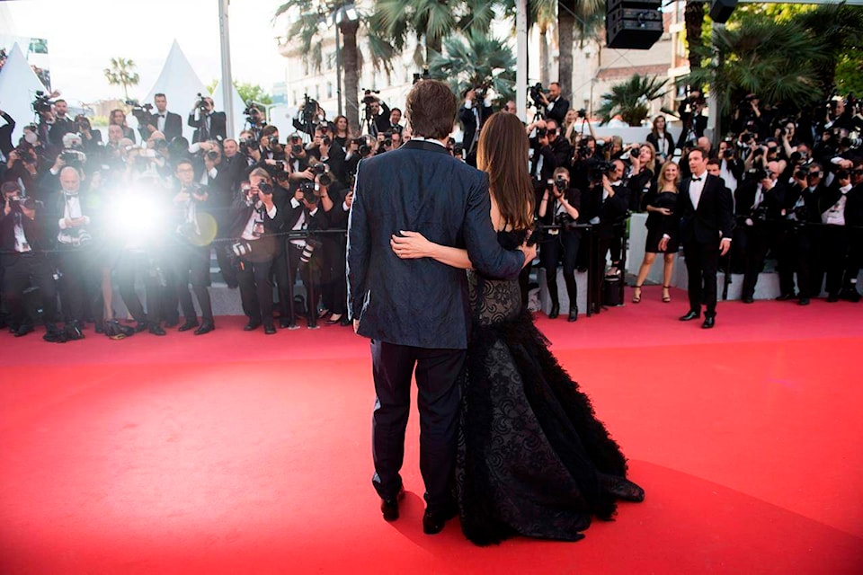 FILE - In this May 8, 2018 file photo, actors Penelope Cruz, right, and Javier Bardem pose for photographers at the opening ceremony of the 71st international film festival, Cannes, southern France. Arguably the world’s most prestigious film festival and cinema’s largest annual gathering has postponed its 73rd edition. Organizers of the French Riviera festival, scheduled to take place May 12-23, said they are considering moving the festival to the end of June or the beginning of July. (Photo by Arthur Mola/Invision/AP, File)