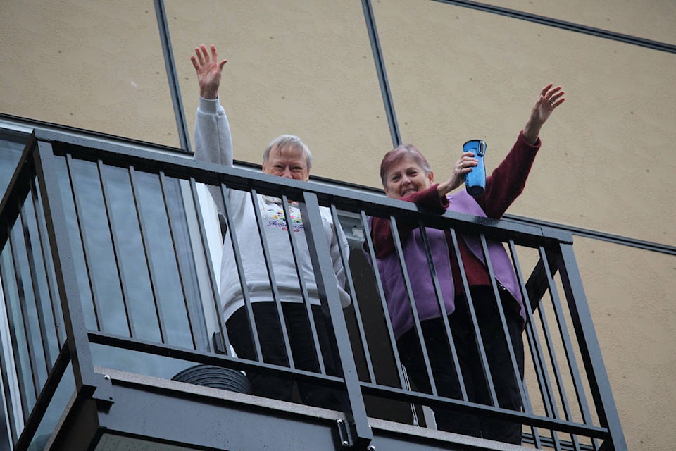 Residents at the Cherish at Central Park retirement community are treated to a courtyard concert so they can enjoy music while social distancing from their balconies. (Shalu Mehta/News Staff)