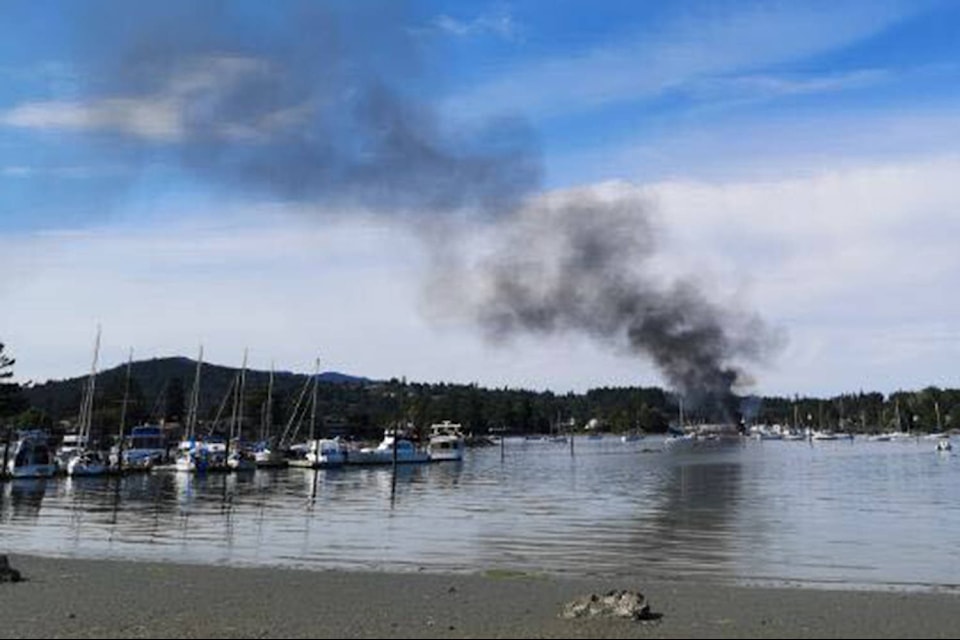 The fire that killed one man in his 50s and injured two and destroyed multiple vessels at North Saanich Marine Sunday afternoon sent a large plume of smoke into the sky that was visible across the region, with this picture being taken from Sidney. (Submitted)