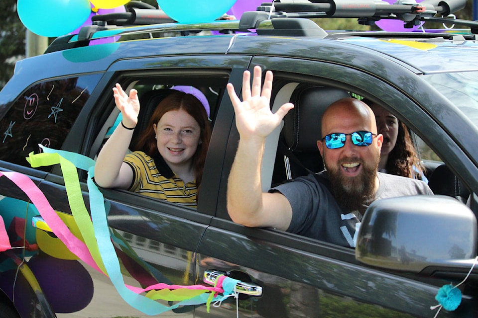 People in vehicles smiled and waved as they rolled by residents on the West Shore as part of the Colwood Church Cruise. (Shalu Mehta/News Staff)