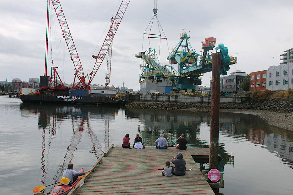 A small crowd gathered to watch as one of Western Canada’s largest crane loaded a 231-tonne stacker reclaimer at Point Hope shipyard on Monday. (Kendra Crighton/News Staff)