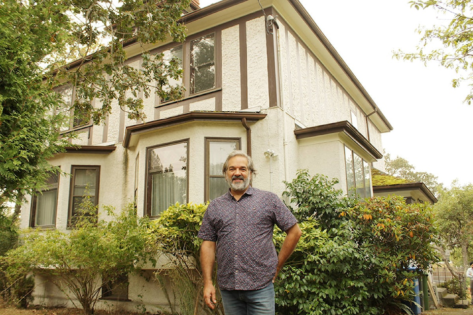 Executive director David Lau, of Victoria Immigrant and Refugee Centre Society, at the Monterey house adjacent to Theatre Lane, where immigrants and refugees can soon live while settling in Canada. (Travis Paterson/News Staff)