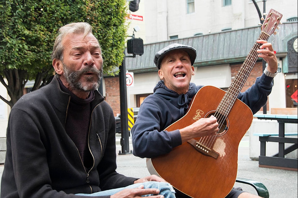 Steve Murrison (left) and David Noel sang songs on Government Street Friday afternoon. (Nina Grossman/News Staff)