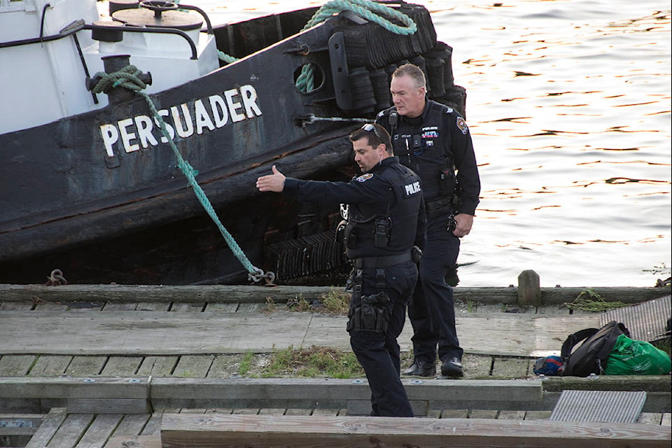 VicPD officers at the Johnson Street bridge for a report of a person in the water on Oct. 14, 2020. (Nina Grossman/News Staff)