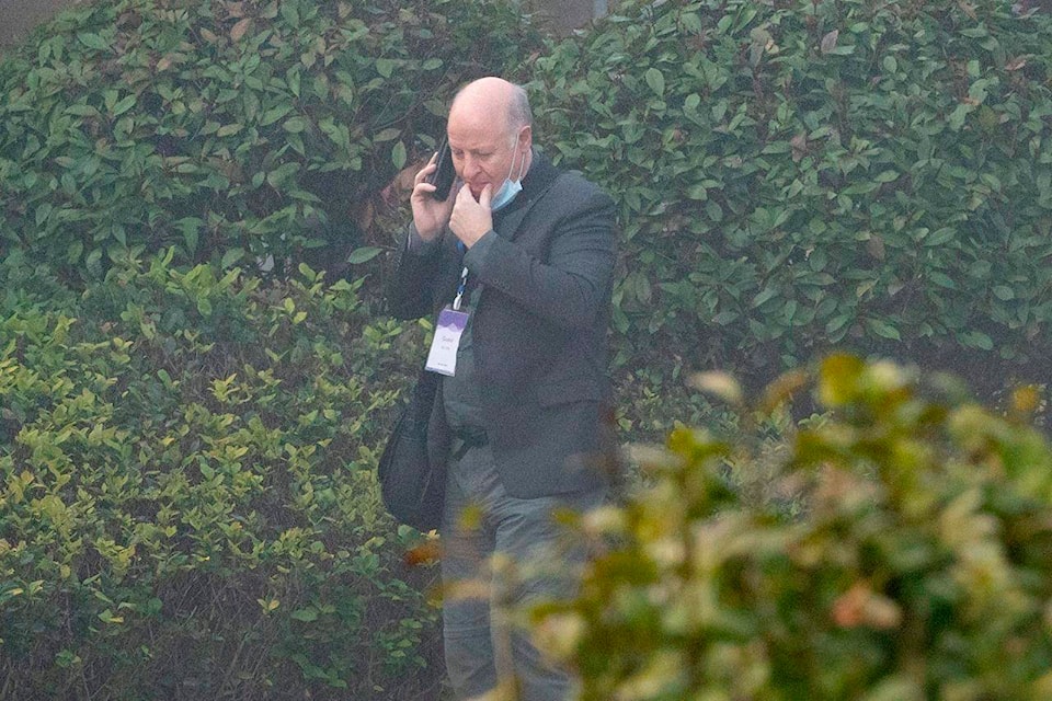 Peter Daszak makes a call on a foggy day before leaving his hotel with other members of a World Health Organization team for another day of field visit in Wuhan in central China’s Hubei province Wednesday, Feb. 3, 2021. The WHO team is investigating the origins of the coronavirus pandemic has visited two disease control centers in the province. (AP Photo/Ng Han Guan)