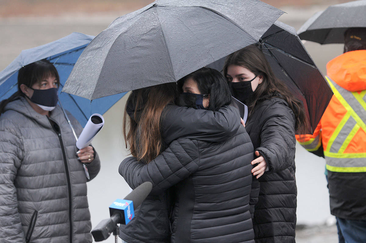 People comfort Alina Durham (centre) after she spoke with media about her missing daughter, Shaelene Bell, on Tuesday, Feb. 2, 2021 on Ballam Road in Chilliwack. (Jenna Hauck/ Chilliwack Progress)