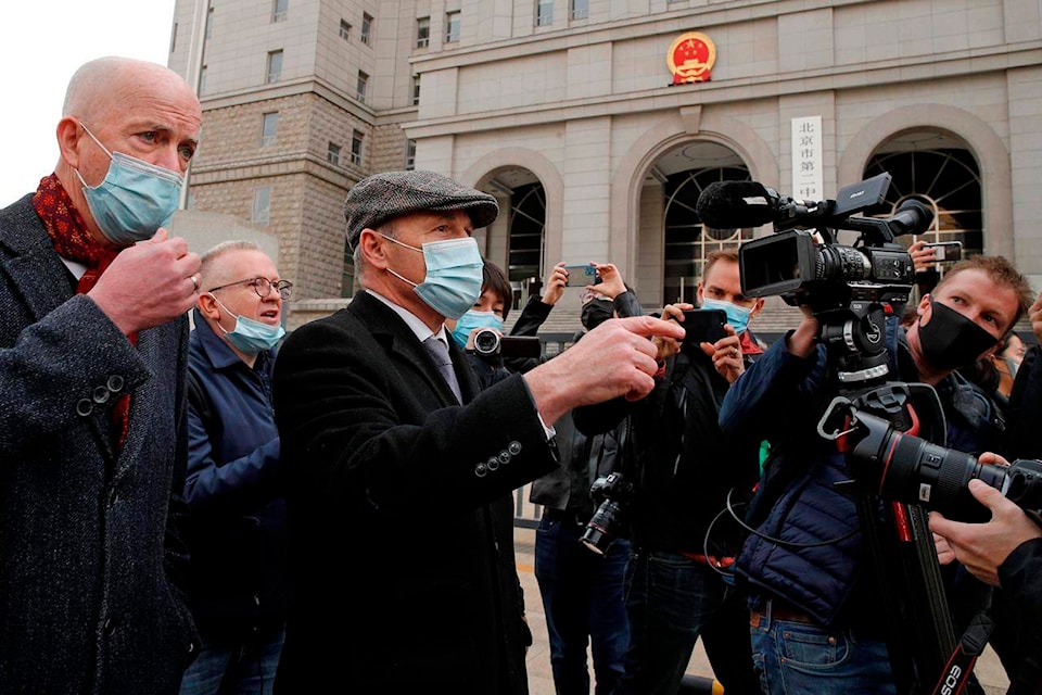 Jim Nickel, center, the deputy chief of mission for the Canadian Embassy in China, with foreign diplomats is chased by cameramen as they arrive at No. 2 Intermediate People’s Court to attend former diplomat Michael Kovrig’s trial in Beijing, Monday, Sept 22, 2021. The Beijing court was is expected to put on trial Monday the second Canadian citizen held for more than two years on spying charges in apparent retaliation for Canada’s arrest of a senior executive of the telecoms giant Huawei. (AP Photo/Andy Wong)