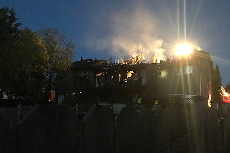 This photo courtesy of Leanne Grover shows the immediate aftermath of the fire at 7987 Galbraith Cres. that caused extensive damage and displaced six residents. (Leanne Grover/Submitted)