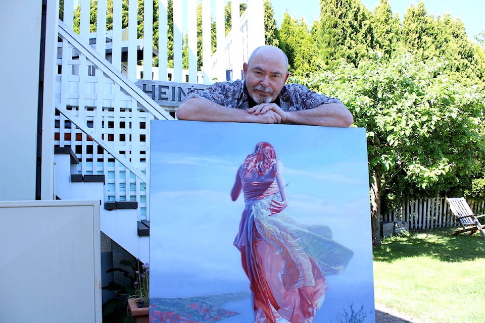 Victoria artist Mark Heine with a painting from his Sirens series. Two pieces from the series will go to the moon later this year. (Jake Romphf/ News Staff)