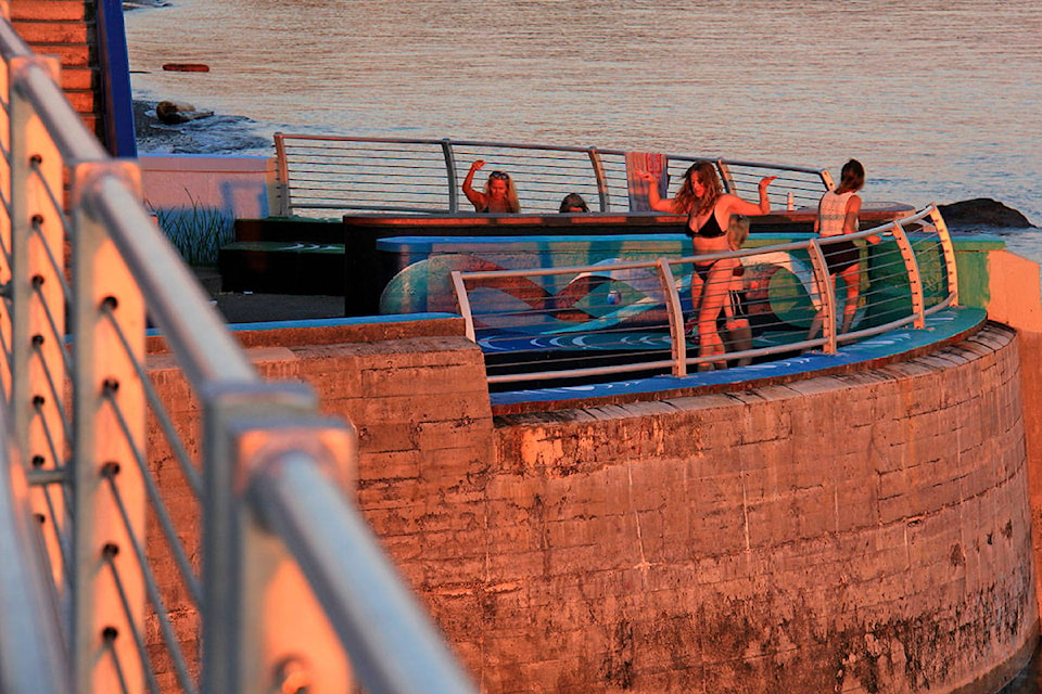 A group of young people danced under the glow of the setting sun and temperatures began to let up Monday evening. (Jane Skrypnek/News Staff)