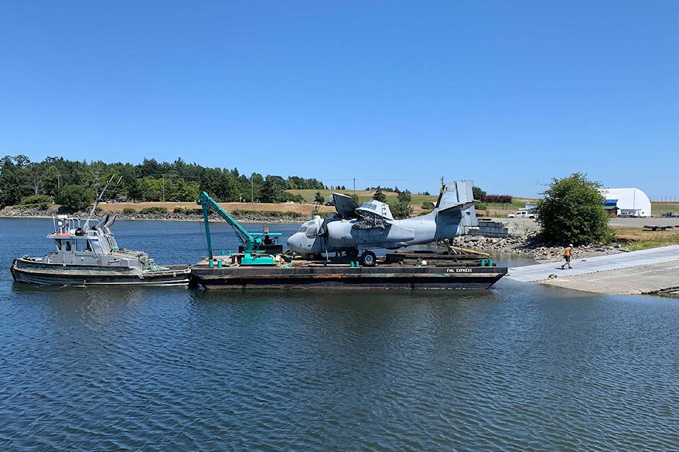 The long-awaited CP-121 Tracker aircraft arrives by barge in Patricia Bay July 5 before making its final trek to the B.C. Aviation Museum in North Saanich. (Wolf Depner/News Staff)
