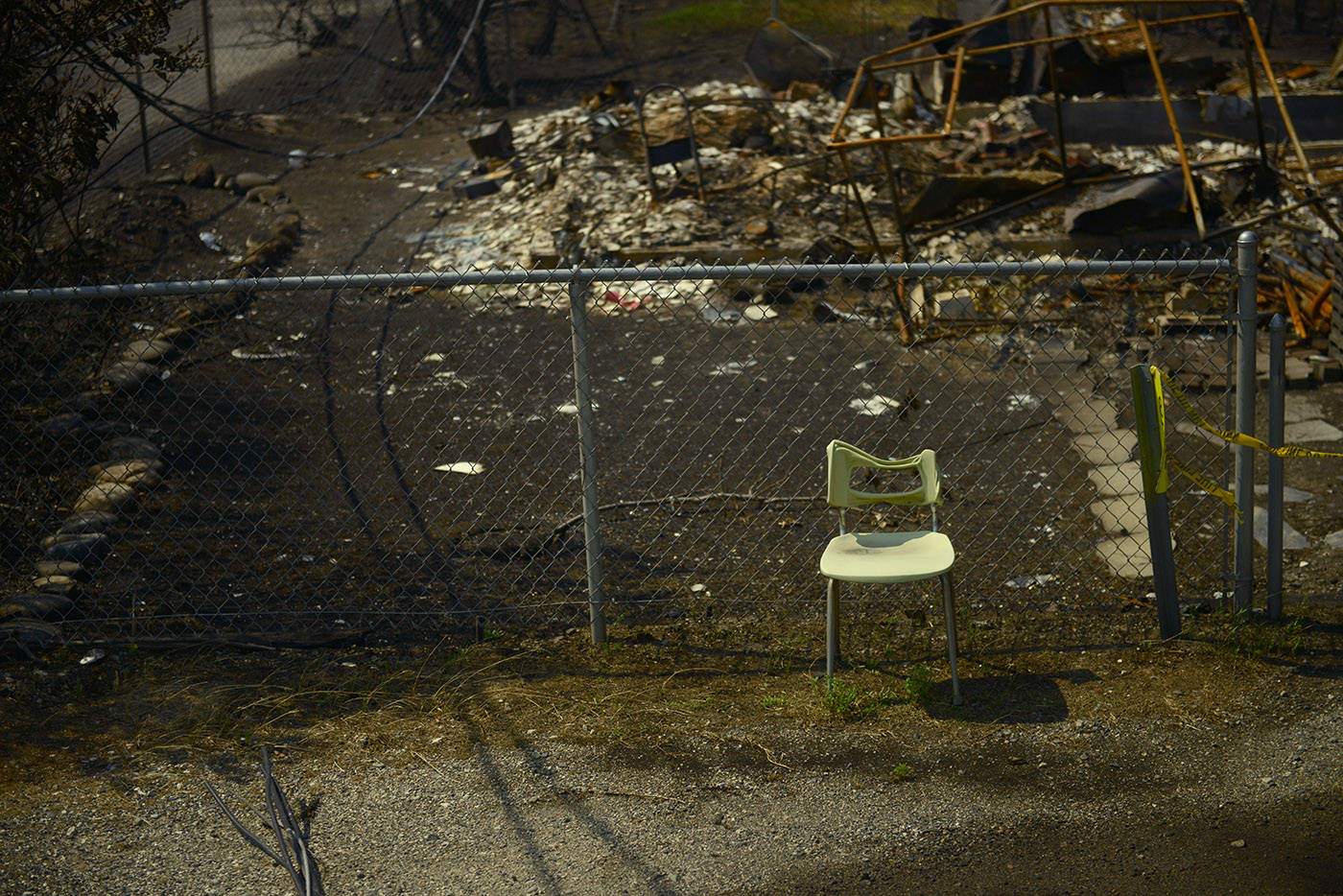 A partially melted chair stands amid the burnt rubble on Main Street in the Village of Lytton, B.C. on Friday, July 9, 2021 following a massive wildfire that tore through the town destroying 90 per cent of it. (Jenna Hauck/ Black Press Media)