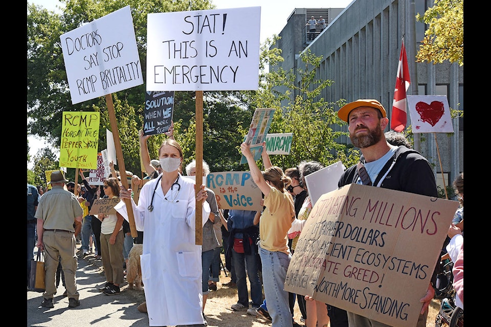 Protesters supporting the Fairy Creek old-growth logging blockade gather outside RCMP headquarters on Blanshard Street at Nanaimo Street in Victoria. (Don Denton/Black Press Media)