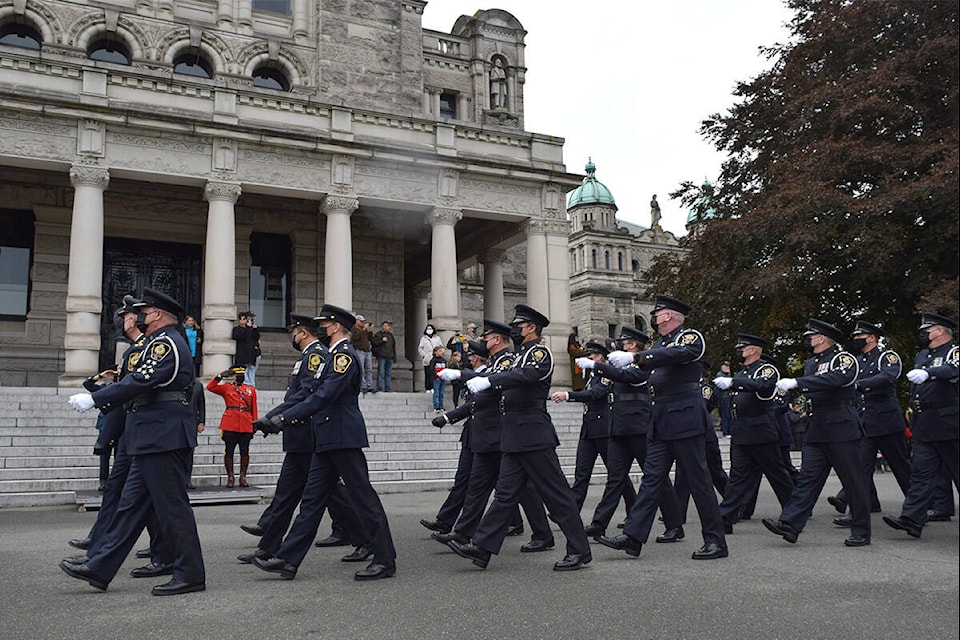 Delta officers march in ranks past Lt.-Gov. Janet Austin behind the B.C. legislature. (Kiernan Green/News Staff)