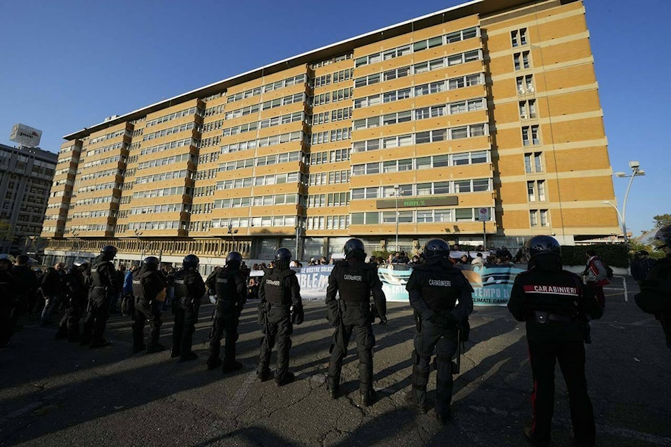 Italian Carabinieri paramilitary police block climate activists showing banners in front of the Italian Ministry of the Ecological Transition in Rome’s via Cristoforo Colombo, one of the main road leading to La Nuvola (the cloud) convention center where the G20 summit is taking place, Saturday, Oct. 30, 2021. (AP Photo/Luca Bruno)
