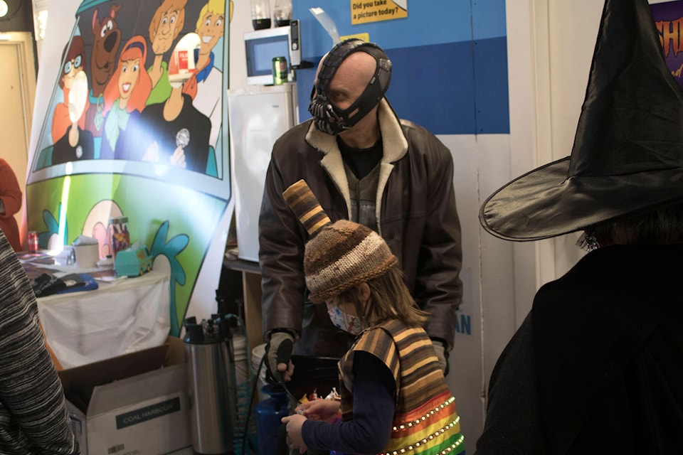 Bane gives out candy at the event, held at M2 Graphix on Langford Parkway on October 1, 2021. (Bailey Moreton/News Staff)