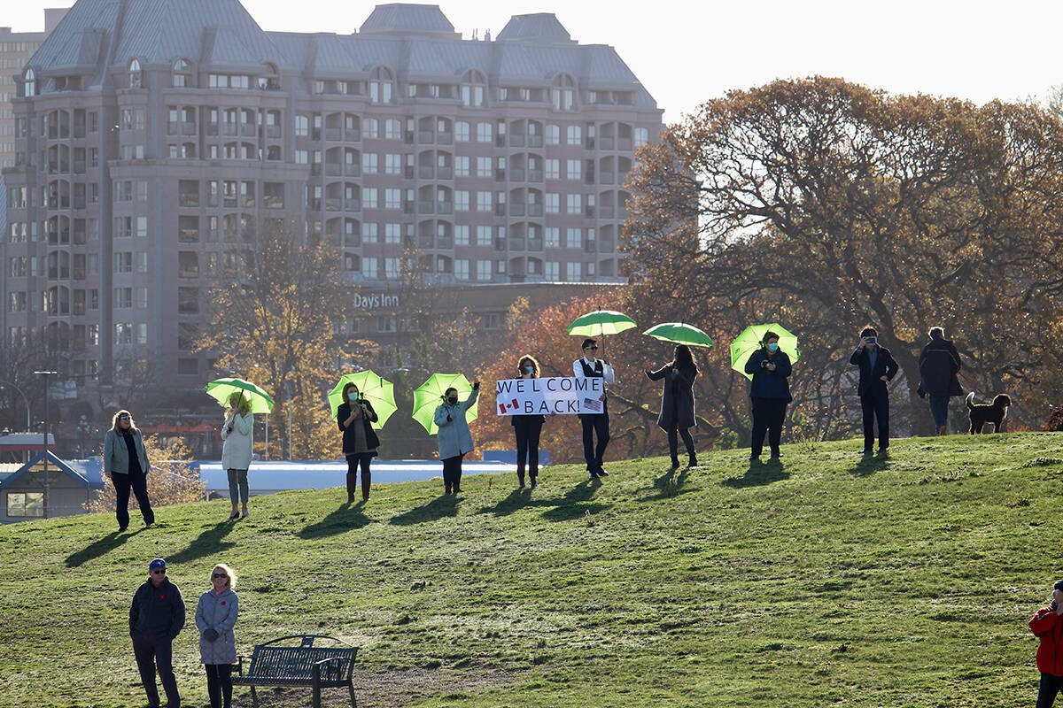 From the lawn of the Inn at Laurel Point, people welcome the M.V. Coho back to Victoria. Amy Attas Photo.