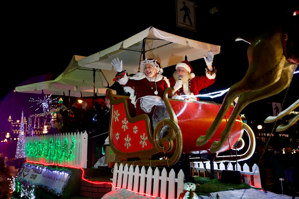 Mrs. Claus and Santa Claus wave to onlookers as they make their way down Government Street during the 2021 Peninsula Co-Op Santa Light Parade Saturday, Nov. 27. (Justin Samanski-Langille/News Staff)