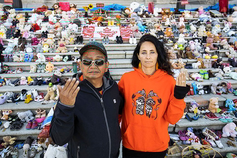Residential school survivor Eddy Charlie (left) and friend Kristin Spray at the parliament buildings in Victoria. (Arnold Lim/Black Press)