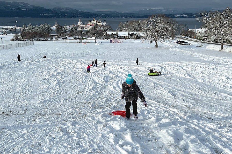 Following an overnight snow fall, children hit the sledding hit off Mills Road in North Saanich near Victoria International Airport Tuesday morning. (Black Press Media photo)