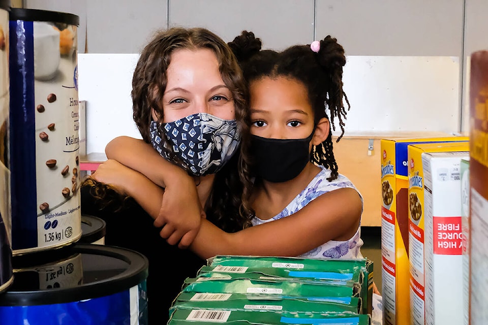 Oaklands Community Association pantry founder Karin Zylstra and daughter Yisa pause amidst the pantry offerings. The pay-what-you-can program has been growing in recent months as people learn more about its fresh offerings and welcoming environment. (Photo by Sandy Yong/courtesy OCA)