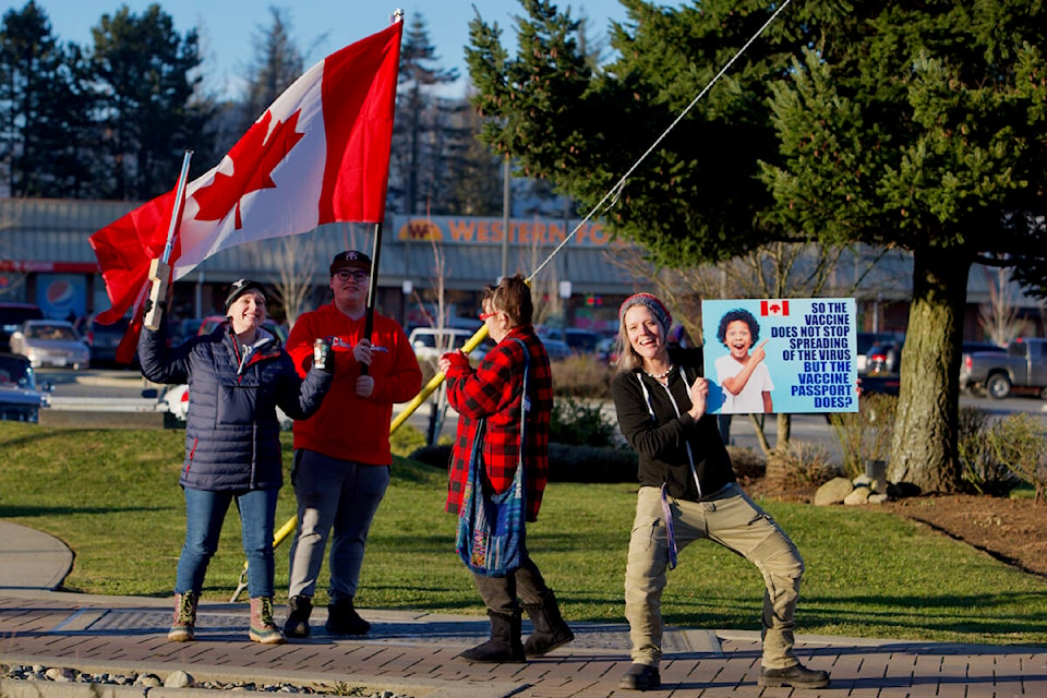 A group of demonstrators show their support for the Freedom Convoy Wednesday afternoon in Sooke. The convoy is a cross-Canada demonstration by truck drivers against government mandates introduced during the pandemic, including a requirement that truck drivers crossing a border must show proof of vaccination.