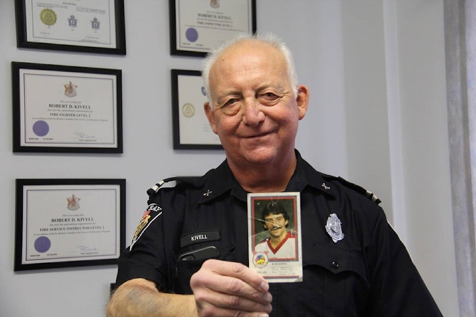 Capt. Rob Kivell displays a hockey card showcasing his job before firefighting – on the ice with a Calgary Flames affiliate club. (Christine van Reeuwyk/News Staff)