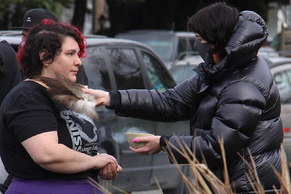 Lindsey Bishop started her walk with a sage smudge, performed by Nicole Mandryk in Victoria Feb. 18. (Christine van Reeuwyk/News Staff)