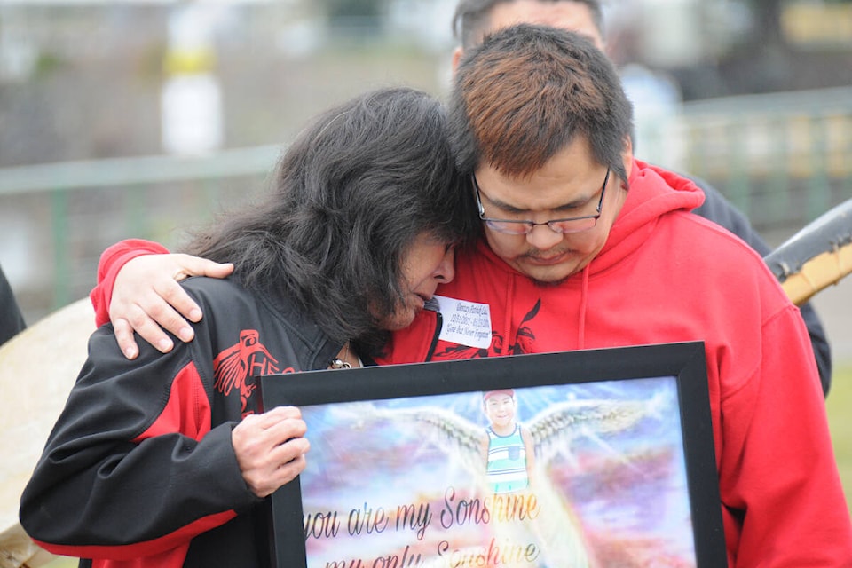 Patrick Lucas and his mother, Florence (Judy) Campbell, hold a framed print featuring Lucas’s son Dontay Patrick, at a vigil March 22, 2022 at Victoria Quay in Port Alberni. Dontay Lucas died four years ago at age six. Father Patrick is still waiting for answers from the RCMP about his son’s death. (SUSAN QUINN/ Alberni Valley News)