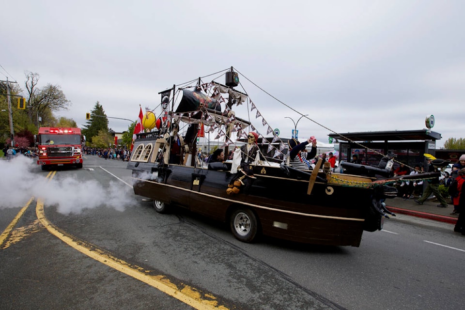 A pirate ship fires its ‘canons’ as it makes its way past hundreds of spectators during the 2022 Esquimalt Buccaneer Days parade Saturday. (Justin Samanski-Langille/News Staff)