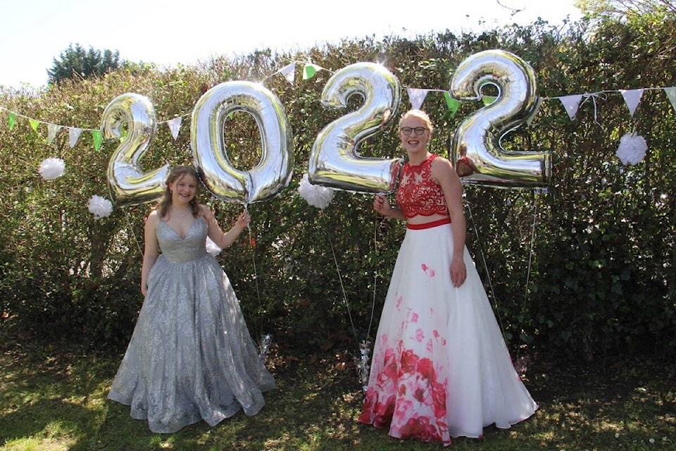 Kathleen Ross (left) and Teagan Blue are among the Oak Bay High grad class of 2022 to gather for photos and friendship at Willows Beach Friday, May 20. (Christine van Reeuwyk/News Staff)