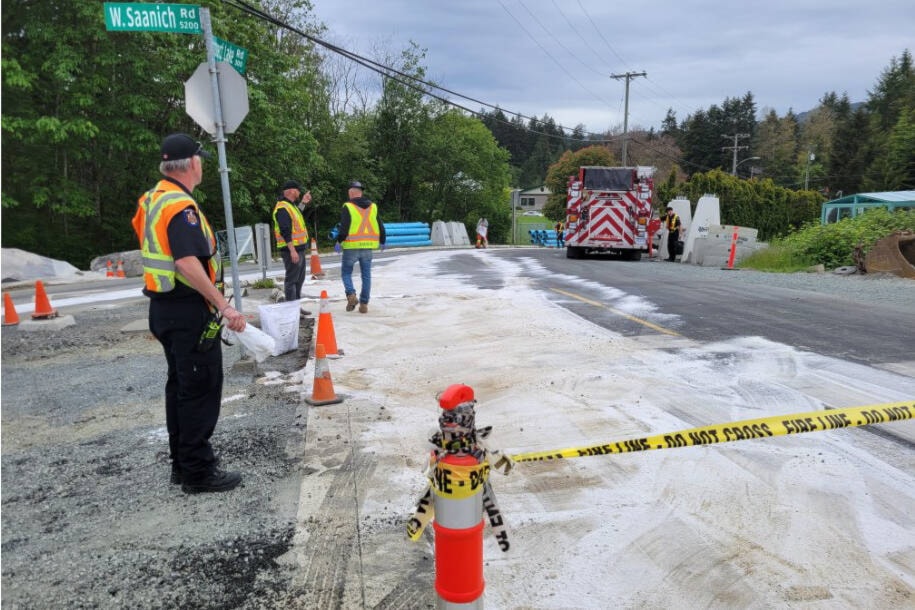 Crews lay down 90 bags of absorbent to sop up a canola oil slick on Prospect Lake Road. (Courtesy District of Saanich)