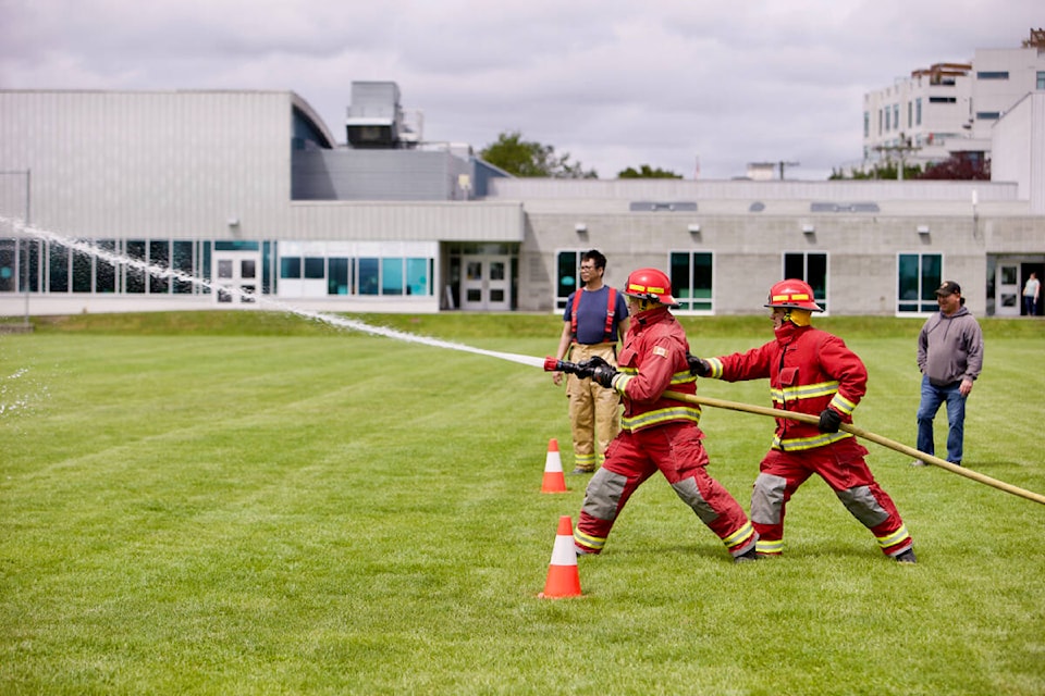 Firefighters aim their hose to knock down a target during the 38th Indigenous Firefighting Competition held in Esquimalt Saturday June 4. (Justin Samanski-Langille/News Staff)