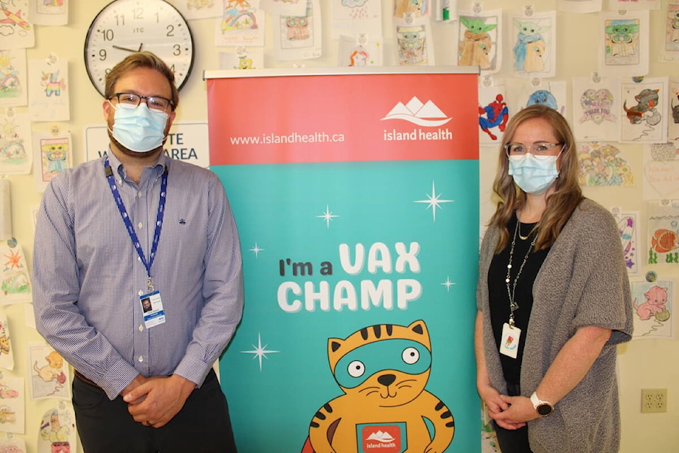Island Health’s Dr. Mike Benusic and public health nurse Sandra Bishop at the Quadra Village Community Centre before the site starts administering vaccines to children between the ages of six months to four years old on Aug. 2. (Jake Romphf/News Staff)