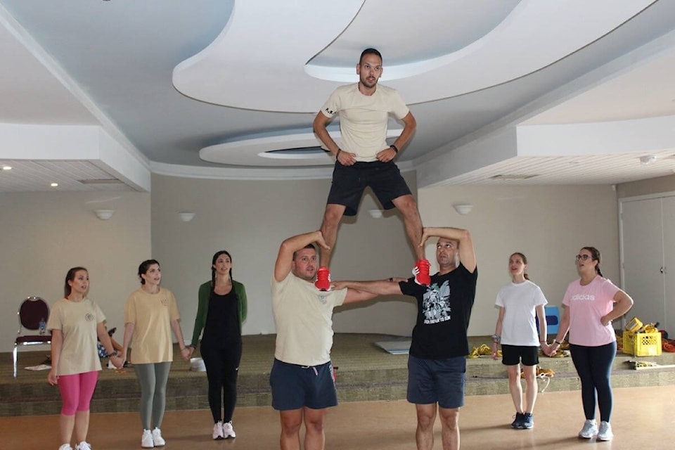 Lykeion Ellinidon, a dance group from Greece, rehearsing inside the community centre before their performance. (Austin Westphal/News Staff)